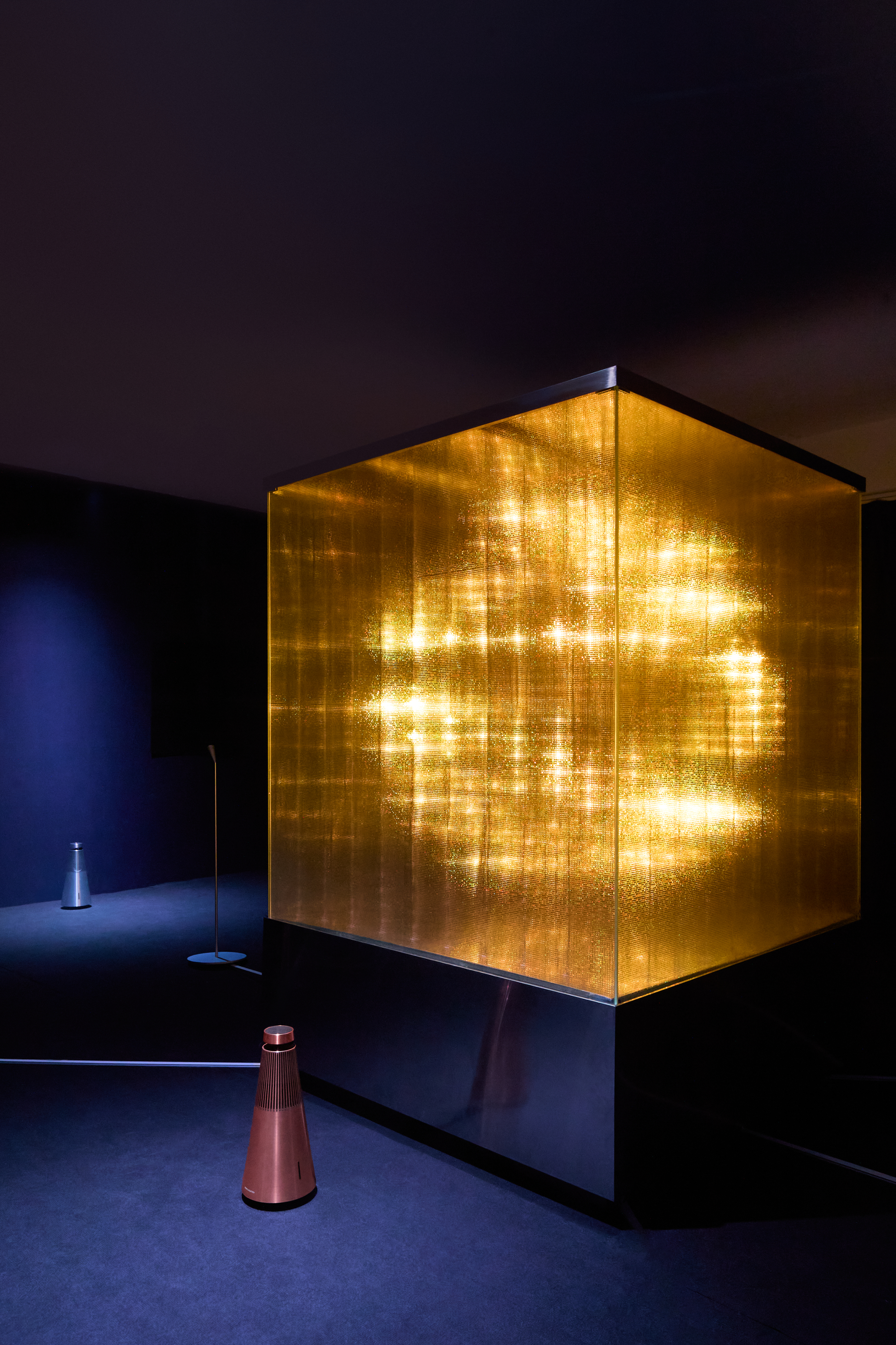 An angled view of the installation in the exhibition room, with the Bang & Olufsen Beosound speaker resting on the floor in the foreground.